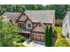 Charming two-story home featuring cedar-shake siding, a brick-accented garage, and a well-manicured front lawn at 2532 Gloster Mill Drive Southwest, Lawrenceville, GA 30044