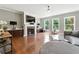 Open living room with hardwood floors, a modern fireplace, and large windows that provide ample natural light at 2532 Gloster Mill Drive Southwest, Lawrenceville, GA 30044