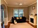 Cozy living room with hardwood floors, a decorative fireplace, a comfortable couch, and a bright window at 2532 Gloster Mill Drive Southwest, Lawrenceville, GA 30044