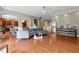 Open-concept living room featuring hardwood floors, a modern sofa, and a seamless transition to the kitchen at 2532 Gloster Mill Drive Southwest, Lawrenceville, GA 30044