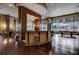 Modern lounge area featuring a bar, hardwood floors, and large windows overlooking the outdoor space at 3040 Peachtree Nw Rd # 1713, Atlanta, GA 30305