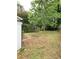 A large backyard featuring a shed and arbor surrounded by trees at 3604 Orchard Cir, Decatur, GA 30032