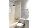 Bathroom boasts a shower/tub with a white tile surround, storage hooks and shower head at 3604 Orchard Cir, Decatur, GA 30032