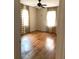 Bedroom features hardwood floors, neutral walls, and checkered curtains at 3604 Orchard Cir, Decatur, GA 30032