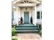 Inviting front porch with a charming door, decorative plants, and a cozy seating area at 3604 Orchard Cir, Decatur, GA 30032