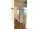 Hallway features white walls, wood floors, white trim and a doorway to the living room at 3604 Orchard Cir, Decatur, GA 30032