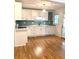 Beautiful kitchen features white cabinets, quartz counters, and aqua subway tile backsplash at 3604 Orchard Cir, Decatur, GA 30032