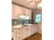 Updated kitchen showcasing white cabinetry, aqua backsplash, and new fixtures at 3604 Orchard Cir, Decatur, GA 30032