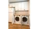 Laundry room includes a side-by-side washer and dryer with white cabinets and wooden countertop at 3604 Orchard Cir, Decatur, GA 30032