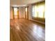 Spacious room showcasing gleaming hardwood floors, sunny windows, and modern curtains at 3604 Orchard Cir, Decatur, GA 30032