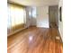 Inviting living room with hardwood floors, large window, and classic decorative curtains at 3604 Orchard Cir, Decatur, GA 30032
