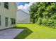 Spacious backyard featuring a concrete patio and verdant lawn at 513 Shadow Valley Ct, Lithonia, GA 30058