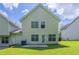 A home's backyard with green grass, patio and vinyl siding at 513 Shadow Valley Ct, Lithonia, GA 30058