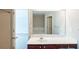 Bathroom vanity with a large mirror, wood cabinets and a view of the bedroom at 513 Shadow Valley Ct, Lithonia, GA 30058
