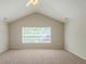 Spacious bedroom with a large window providing natural light and a ceiling fan at 513 Shadow Valley Ct, Lithonia, GA 30058