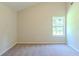 Bright bedroom with high ceilings, large window, and neutral carpet at 513 Shadow Valley Ct, Lithonia, GA 30058