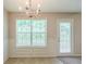 Bright dining area with a window and a door with charming white blinds and wainscoting at 513 Shadow Valley Ct, Lithonia, GA 30058