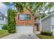 Charming two-story brick home with a white garage door and second story balcony at 513 Shadow Valley Ct, Lithonia, GA 30058