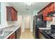 Well-equipped kitchen featuring modern appliances, granite countertops, and ample cabinet space at 513 Shadow Valley Ct, Lithonia, GA 30058