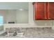 Kitchen with granite counters and double sink overlooking a fireplace in the adjacent room at 513 Shadow Valley Ct, Lithonia, GA 30058