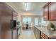 Eat-in kitchen with stainless steel appliances and cherry wood cabinets at 513 Shadow Valley Ct, Lithonia, GA 30058