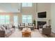 Bright and airy living room featuring a fireplace, high ceilings, and comfortable seating at 513 Shadow Valley Ct, Lithonia, GA 30058