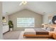 Relaxing main bedroom with vaulted ceilings, a large window, and neutral decor at 513 Shadow Valley Ct, Lithonia, GA 30058
