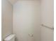 Simple powder room with toilet, and towel rack at 513 Shadow Valley Ct, Lithonia, GA 30058