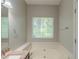 Bright and airy bathroom featuring a large soaking tub, window, and granite countertop at 5341 Terrytown Ln, Lithonia, GA 30038
