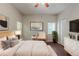 Comfortable bedroom with neutral walls, hardwood floors, and a ceiling fan at 5341 Terrytown Ln, Lithonia, GA 30038