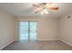 Light-filled bedroom with ceiling fan and sliding glass doors at 5341 Terrytown Ln, Lithonia, GA 30038