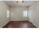 Bright bedroom with neutral walls, ceiling fan, and wood-look floors at 5341 Terrytown Ln, Lithonia, GA 30038