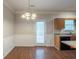 Well-lit dining area with a modern chandelier and direct access to the kitchen at 5341 Terrytown Ln, Lithonia, GA 30038