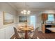 Cozy dining area features a modern chandelier, wainscoting, and views of the backyard at 5341 Terrytown Ln, Lithonia, GA 30038