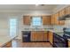 Traditional kitchen features wood cabinets, granite counters, and black appliances at 5341 Terrytown Ln, Lithonia, GA 30038