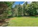Expansive backyard with lush green lawn and mature trees creating a private, serene outdoor space at 901 Chadwick Park Dr, Lawrenceville, GA 30045