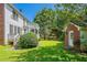 Green backyard with wooden deck and brick shed with white trim at 901 Chadwick Park Dr, Lawrenceville, GA 30045