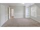 Neutral bedroom boasts plush carpet, natural light, and built in shelving at 901 Chadwick Park Dr, Lawrenceville, GA 30045