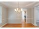 Dining room featuring hardwood floors, a chandelier, and view into the kitchen at 901 Chadwick Park Dr, Lawrenceville, GA 30045