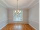 Dining room with hardwood flooring, a chandelier, and large windows at 901 Chadwick Park Dr, Lawrenceville, GA 30045