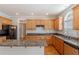 Open kitchen with granite countertops, wood cabinets, stainless appliances, and ample counter space at 901 Chadwick Park Dr, Lawrenceville, GA 30045