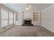 Bright living room features a fireplace with custom built-ins, large windows, and neutral carpet at 901 Chadwick Park Dr, Lawrenceville, GA 30045