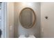 Small powder room featuring a mirror, sink, and classic fixtures at 901 Chadwick Park Dr, Lawrenceville, GA 30045