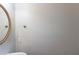 Compact powder room featuring a round mirror and single sink at 901 Chadwick Park Dr, Lawrenceville, GA 30045