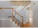 Elegant staircase with wooden railing, carpeted steps, and a nearby doorway at 901 Chadwick Park Dr, Lawrenceville, GA 30045