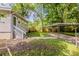 View of the backyard and car port with surrounding landscaping at 2245 Dauphine St, Atlanta, GA 30344