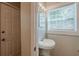 Bathroom featuring a sink, window with natural light, and door at 2245 Dauphine St, Atlanta, GA 30344