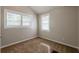 Neutral bedroom featuring two windows, plush carpeting, and ample natural light at 2245 Dauphine St, Atlanta, GA 30344