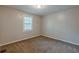Bedroom with neutral paint, carpeted floor, and a window with light coming through at 2245 Dauphine St, Atlanta, GA 30344