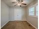 A bedroom features neutral walls, carpet, a ceiling fan, and natural light at 2245 Dauphine St, Atlanta, GA 30344
